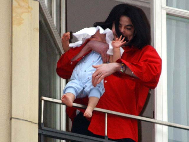 Michael Jackson dangling his baby over the balcony