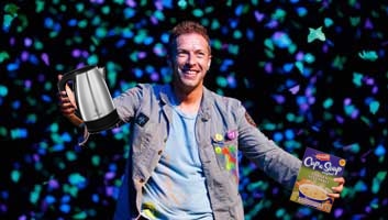 chris martin holding a cup a soup